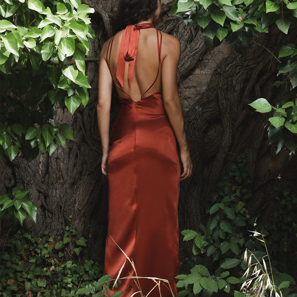 High neck, backless slip dress in double-sided silk, with side slit available in ankle length and full length 100% silk.