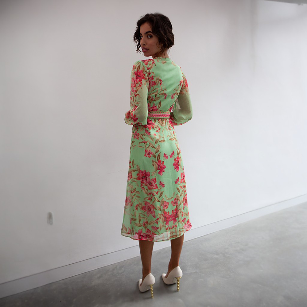 The Naomi Dress is a beautiful light green midi dress featuring a floral pink print. 