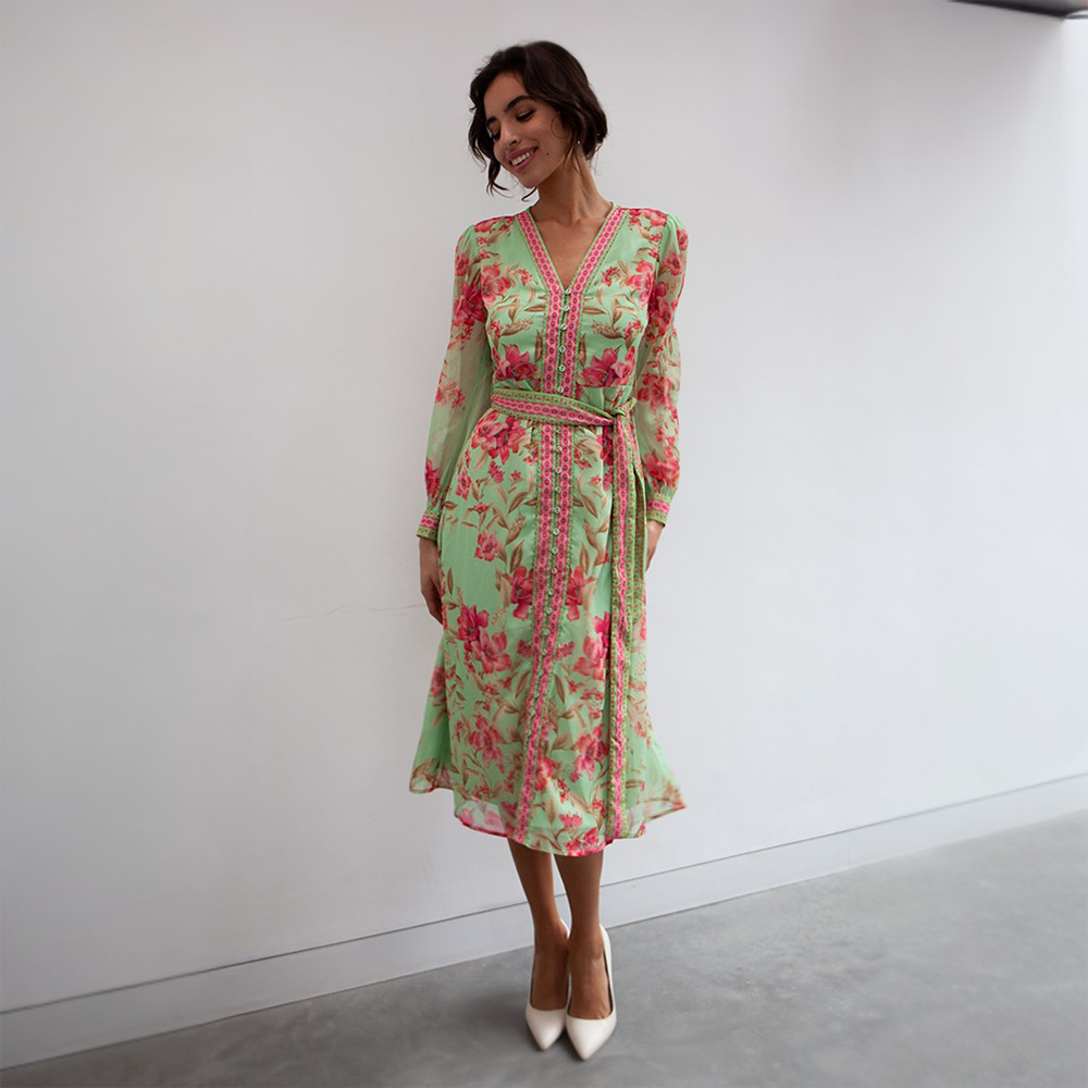The Naomi Dress is a beautiful light green midi dress featuring a floral pink print. 