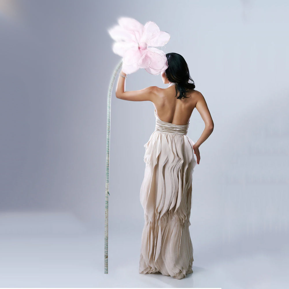 Beige halter maxi dress with V-neck and ruched waist, perfect for events. Shop online from our exclusive collection of premium styles.