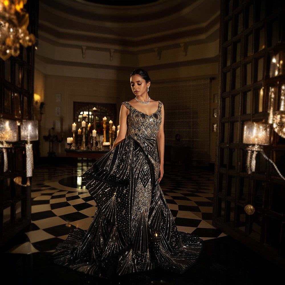 Scintillating Cosmos depicted through Signature embroideries with wraparound bustle over pillar gown with train.