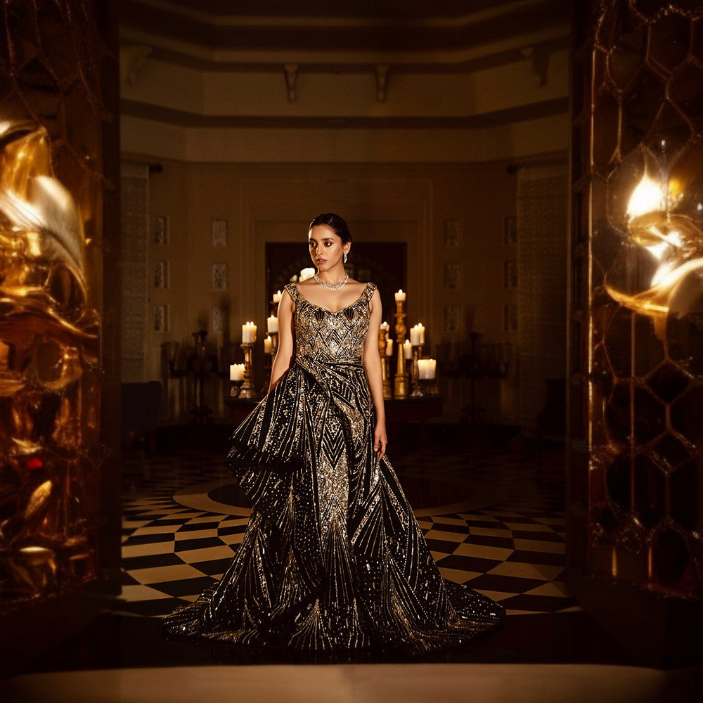 Scintillating Cosmos depicted through Signature embroideries with wraparound bustle over pillar gown with train.