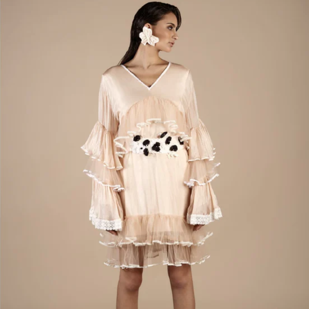 The Nude Silk Tiered Lace Dress exudes timeless elegance with its delicate design. 