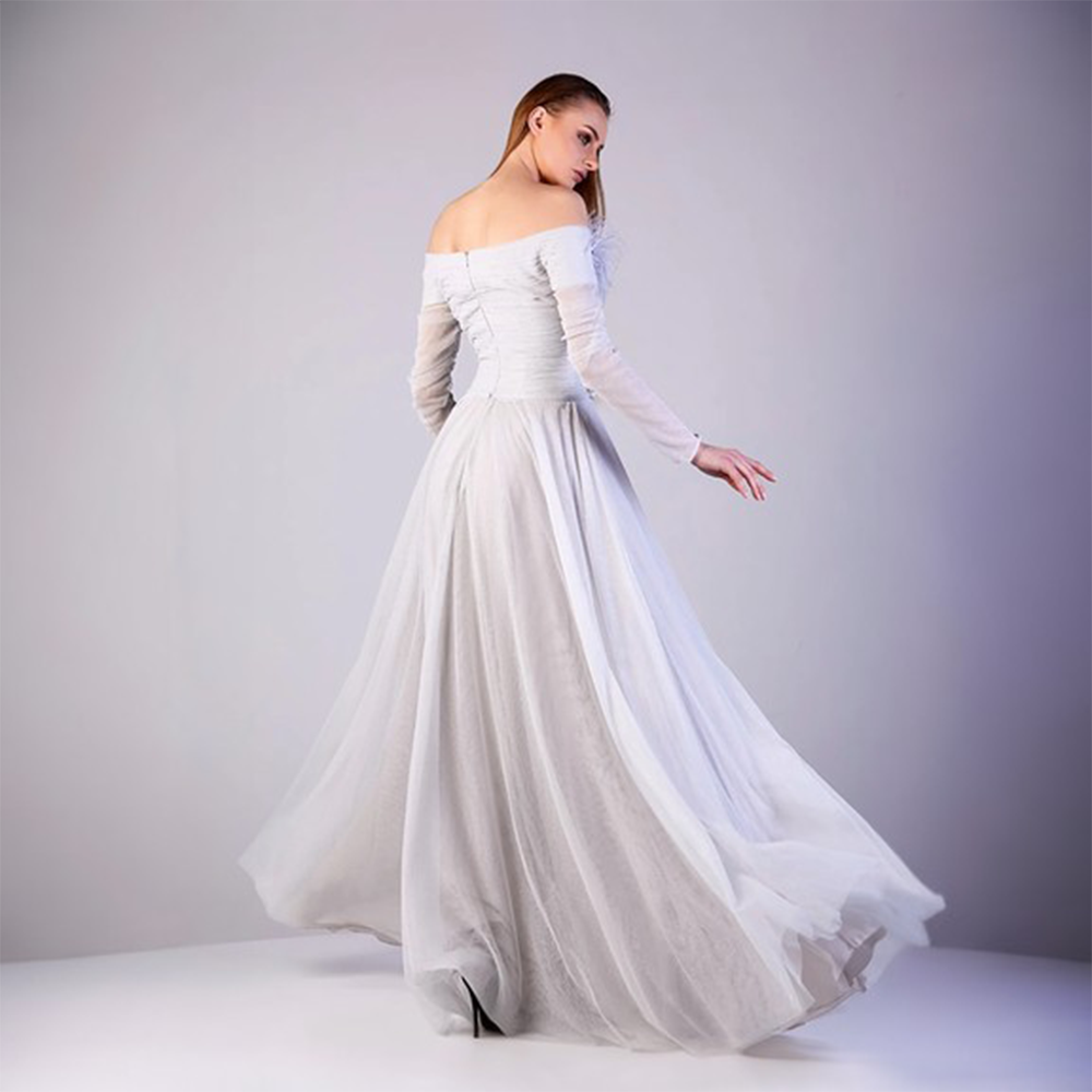 Off shoulder fringes full sleeves with fitted bodice connected with gathered front slit lower bodice. 