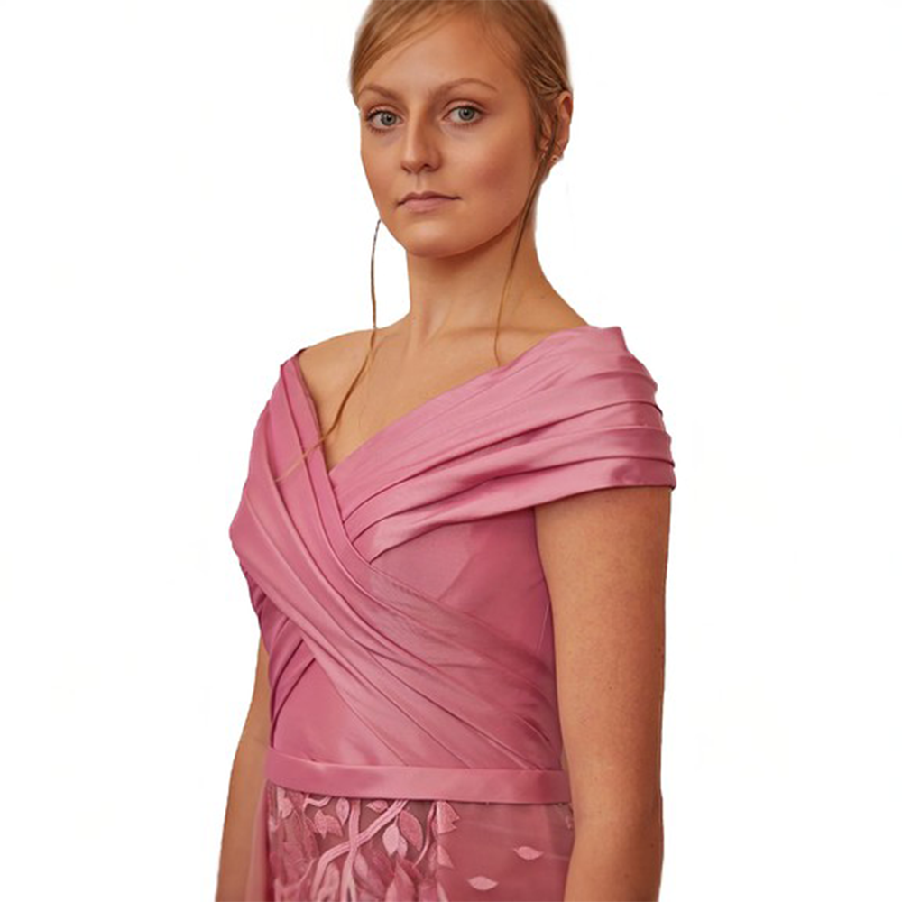 Overlap fitted bodice with falling shoulders connected with dramatic box pleated embroidered lower bodice. 