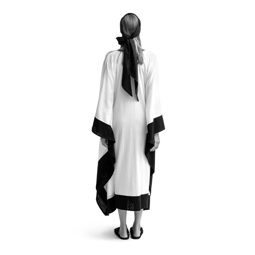 Discover the Ocean Cover at The Luxe Maison, featuring airy cotton batiste, a relaxed poncho silhouette, contrasting trims, and a front slit.