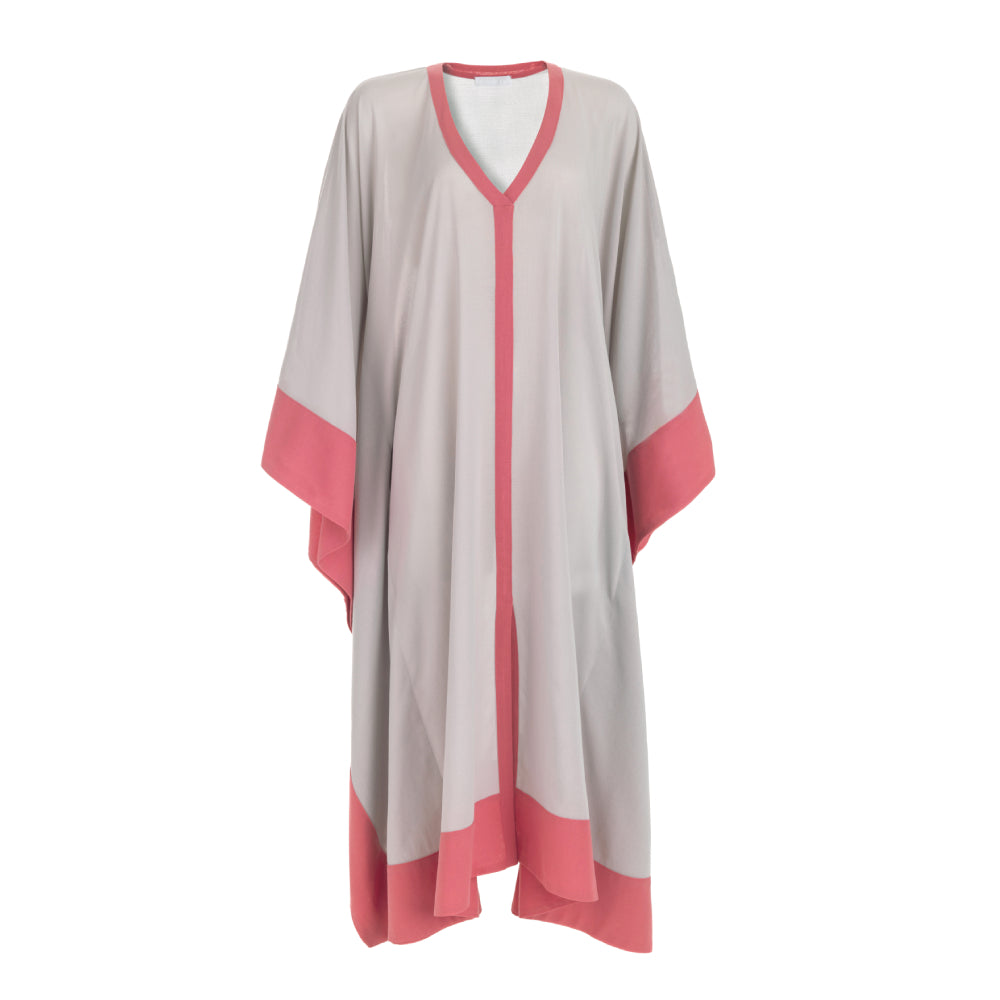 Discover the Ocean Cover at The Luxe Maison, featuring airy cotton batiste, a relaxed poncho silhouette, contrasting trims, and a front slit.