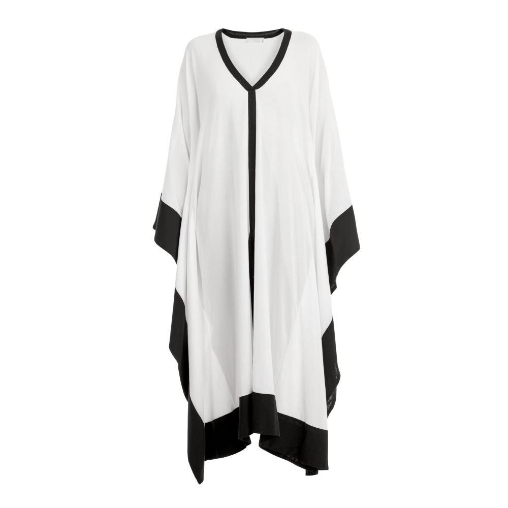 Discover the Ocean Cover at The Luxe Maison, featuring airy cotton batiste, a relaxed poncho silhouette, contrasting trims, and a front slit.