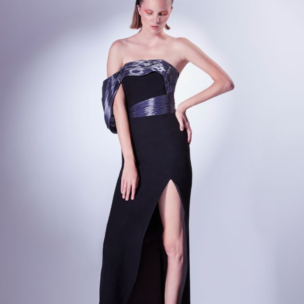 This elegant dress crafted in a black crepe base, the dress is outlined by the sartorial organdie element.