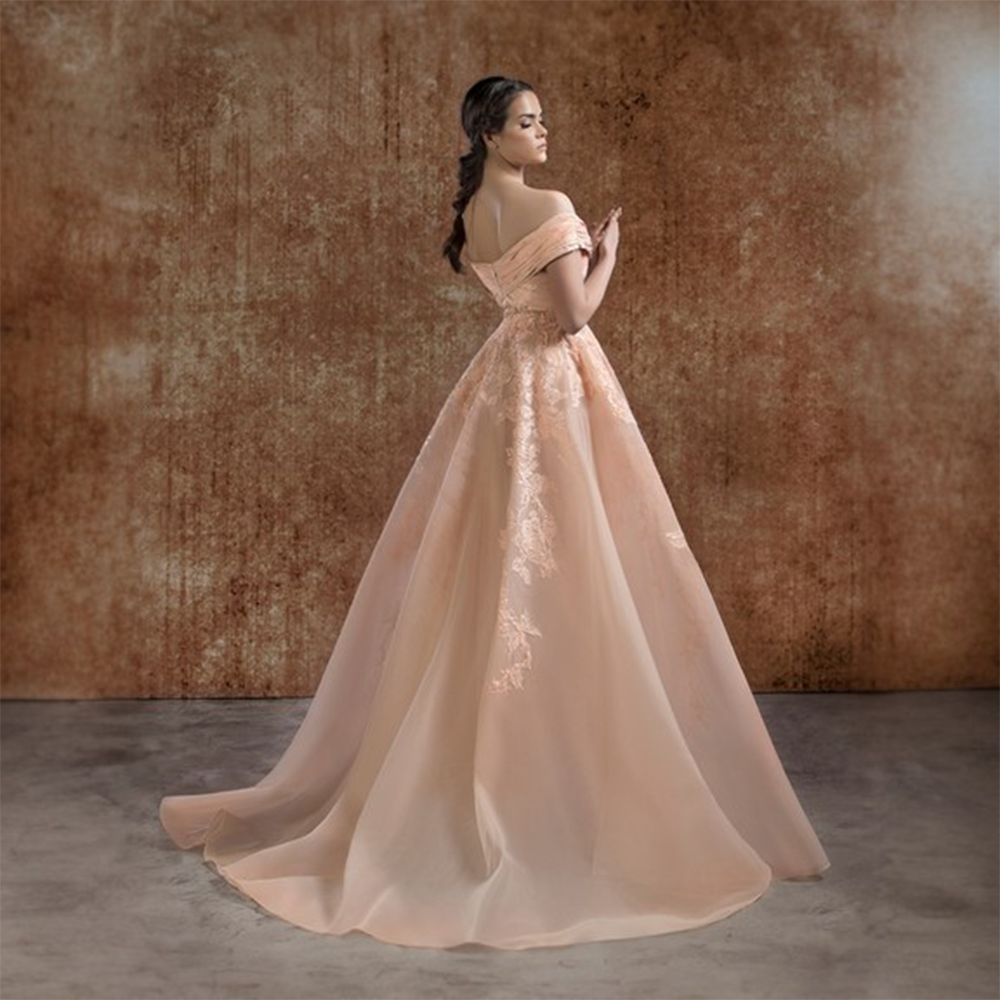 Peach off the shoulders a-shape crin dress with shiny draping on bust . Embroidered flowers encrusted all over dress.