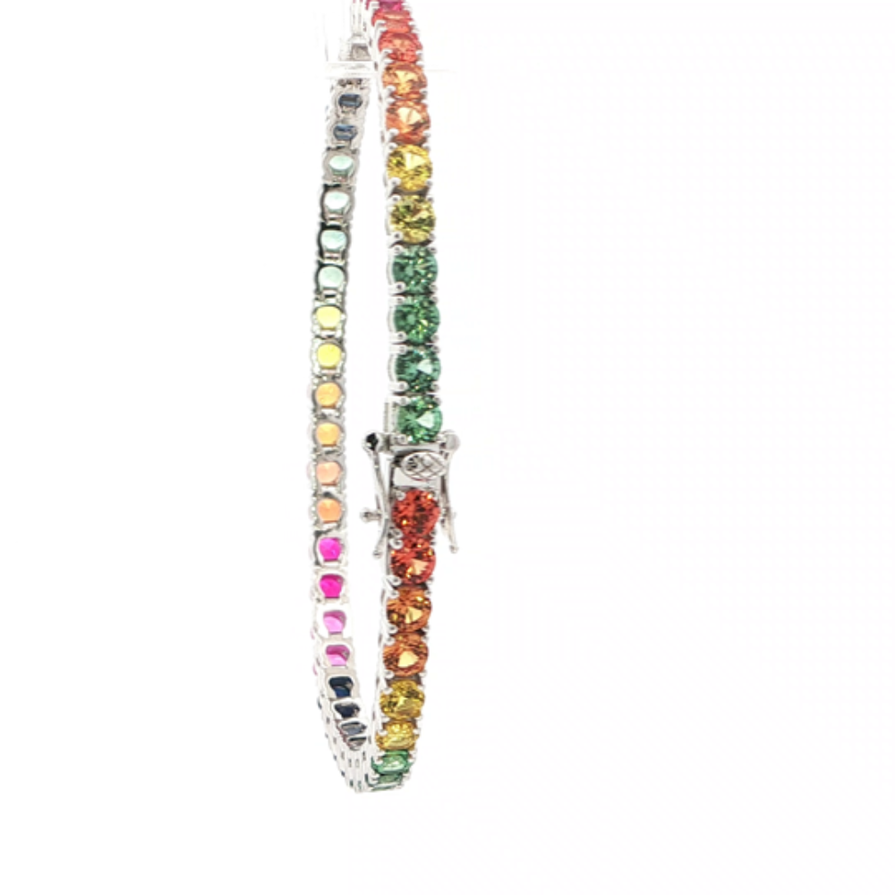 Rhodium-plated sterling silver rainbow ombre bracelet with lab-created yellow, pink, orange, blue, and green sapphire stones with ruby accents for a vibrant modern look. Shop premium jewelry online.