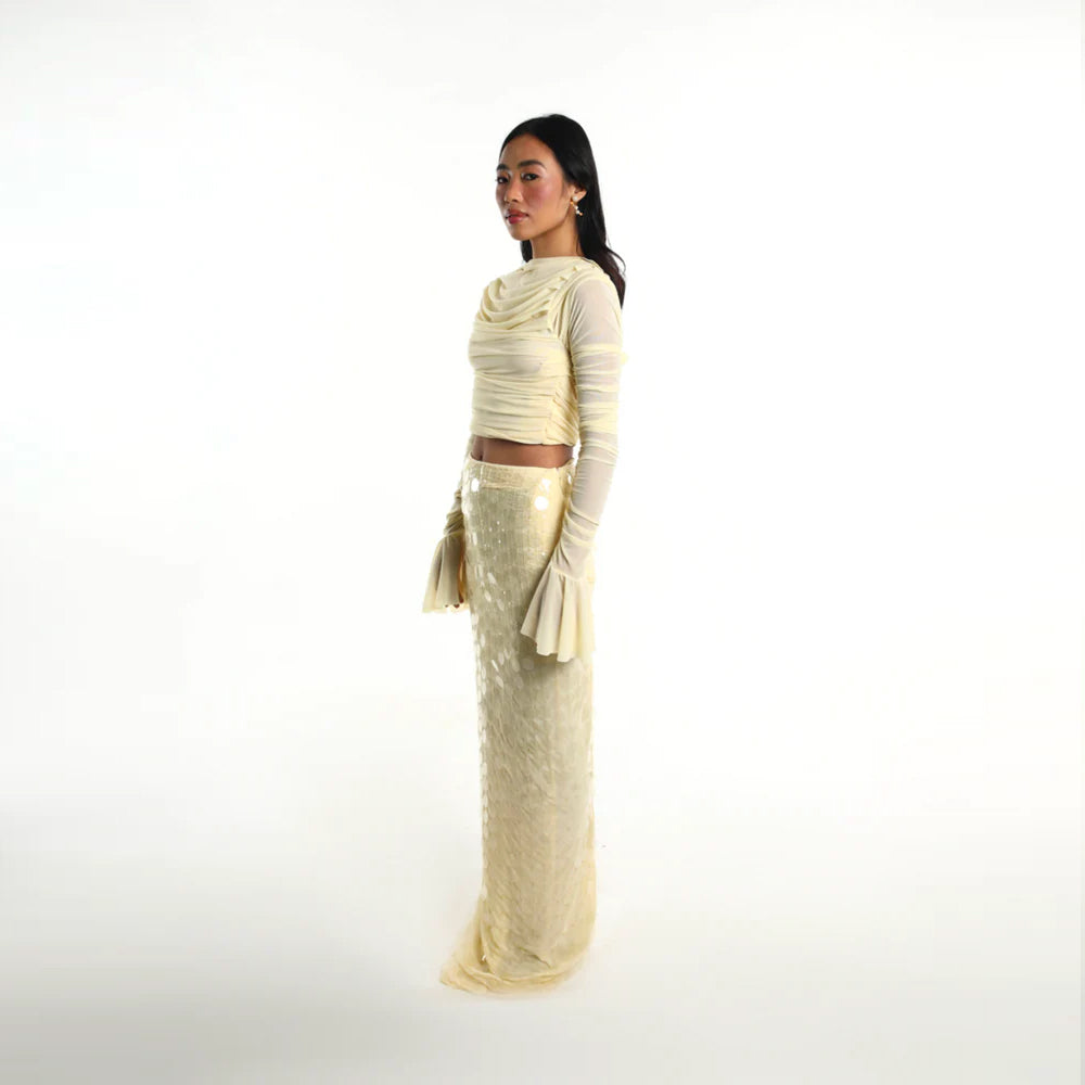 Pastel yellow set with ruched mesh top and sequin skirt, perfect for parties. Shop online from our curated edit of premium fashion.