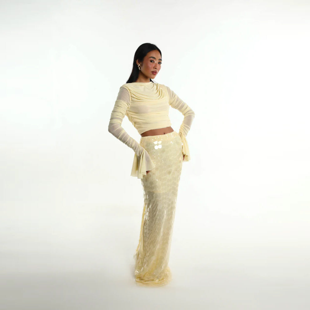 Pastel yellow set with ruched mesh top and sequin skirt, perfect for parties. Shop online from our curated edit of premium fashion.