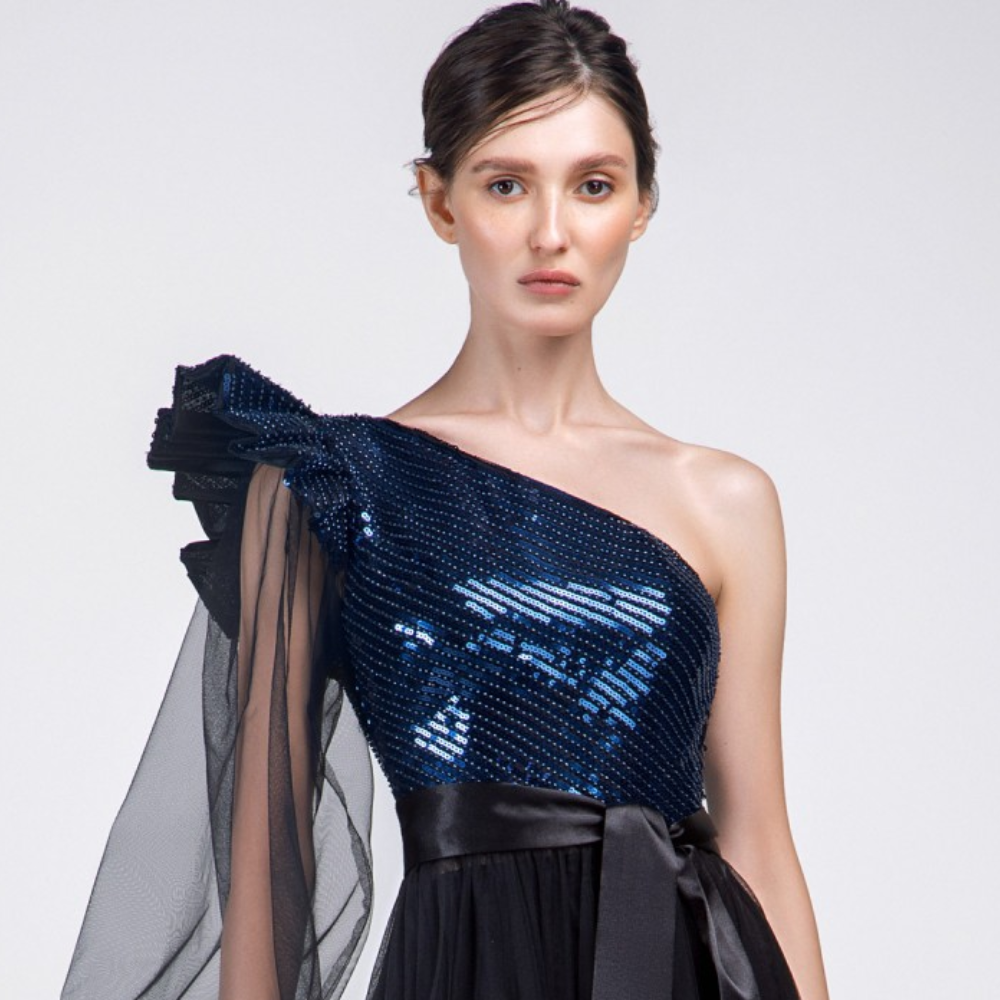 One shoulder, Puffy sleeves Floor lenth long dress. Beaded royal blue sequined top and a black multi layered tulle skirt .