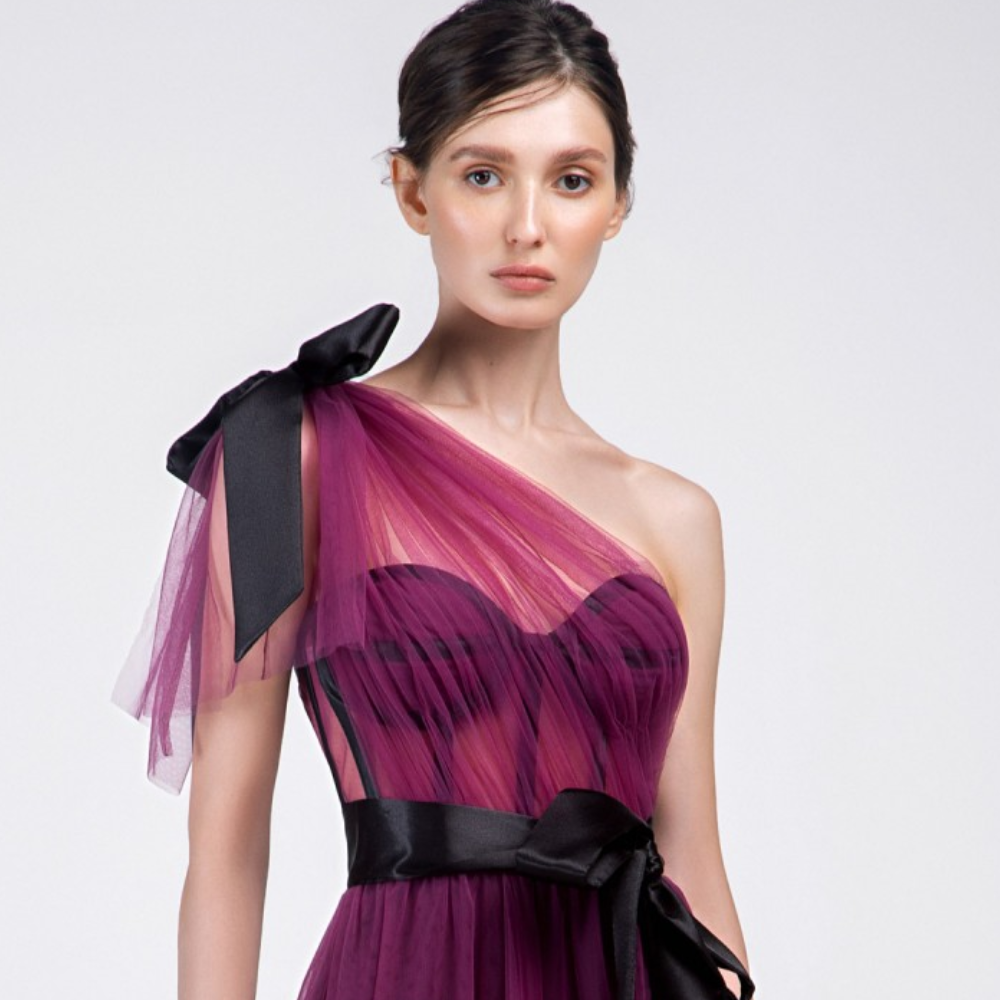 One shoulder, floor-length long dress. Multi-layered purple tulle dress with short pants and black belt.