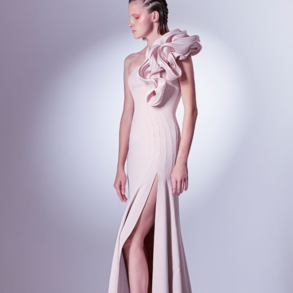 Romantically tailored in a mermaid silhouette, this dress is adorned with a manipulated organdie element at the shoulder. 