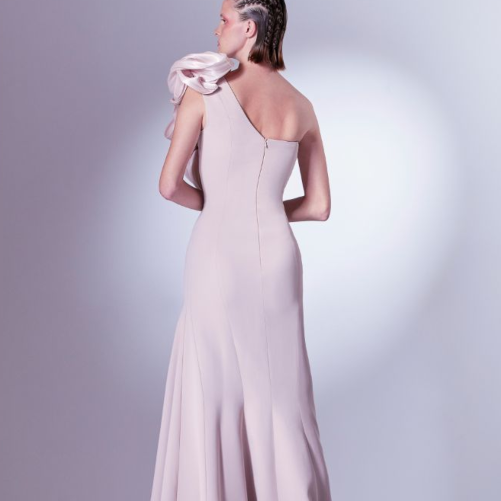 Romantically tailored in a mermaid silhouette, this dress is adorned with a manipulated organdie element at the shoulder. 