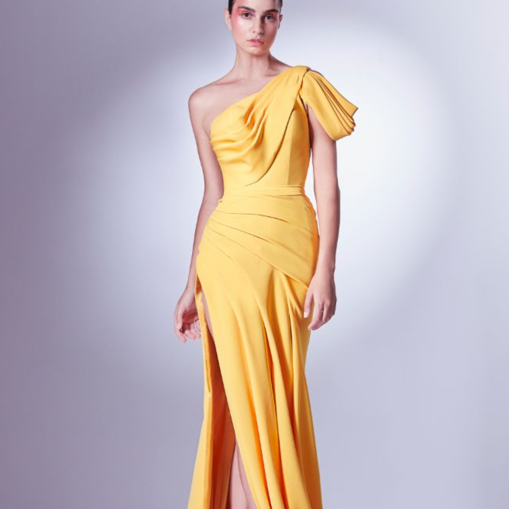 Rendered in a vibrant mango yellow, this dress is an avant-garde addition to our Fall Winter collection.