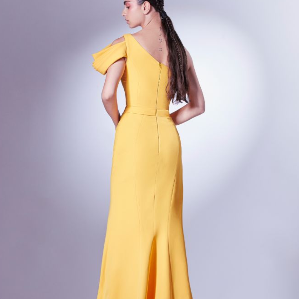 Rendered in a vibrant mango yellow, this dress is an avant-garde addition to our Fall Winter collection.