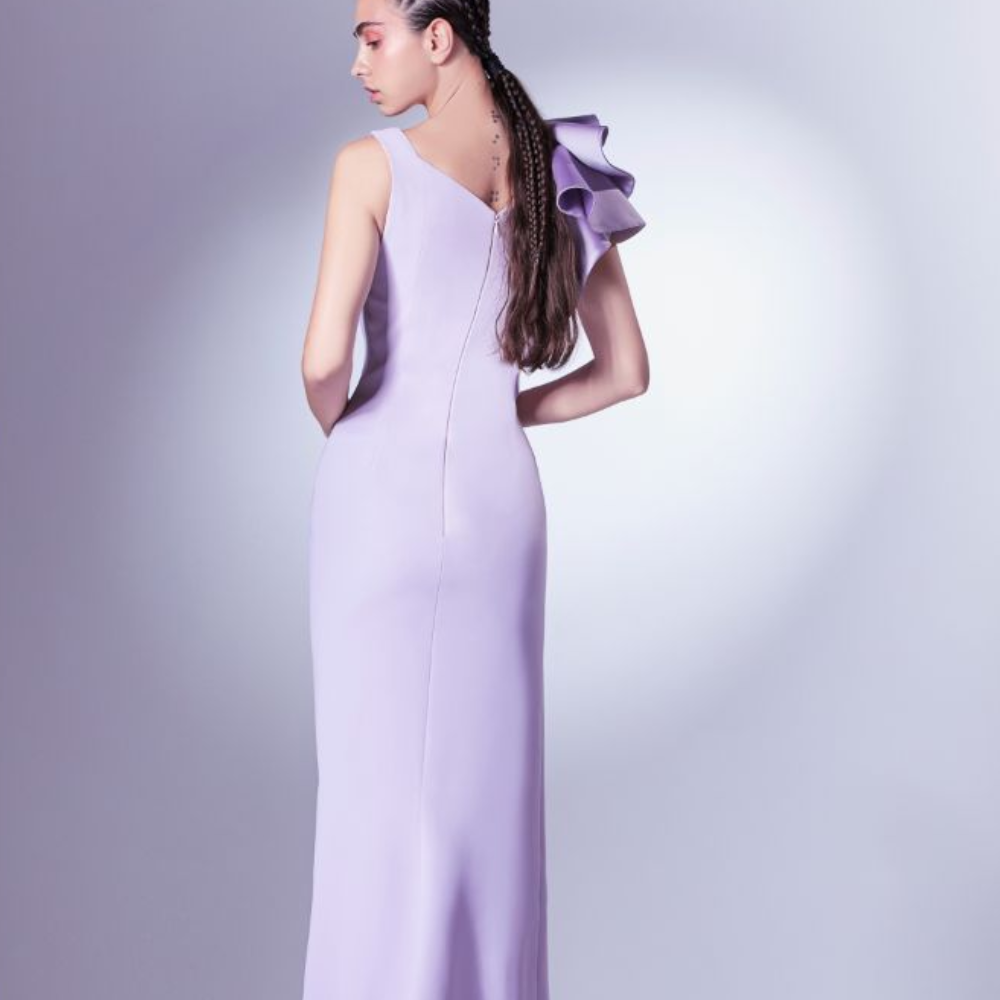 This one shoulder dress is constructed with crepe base and a satin ruffle at the shoulder. 