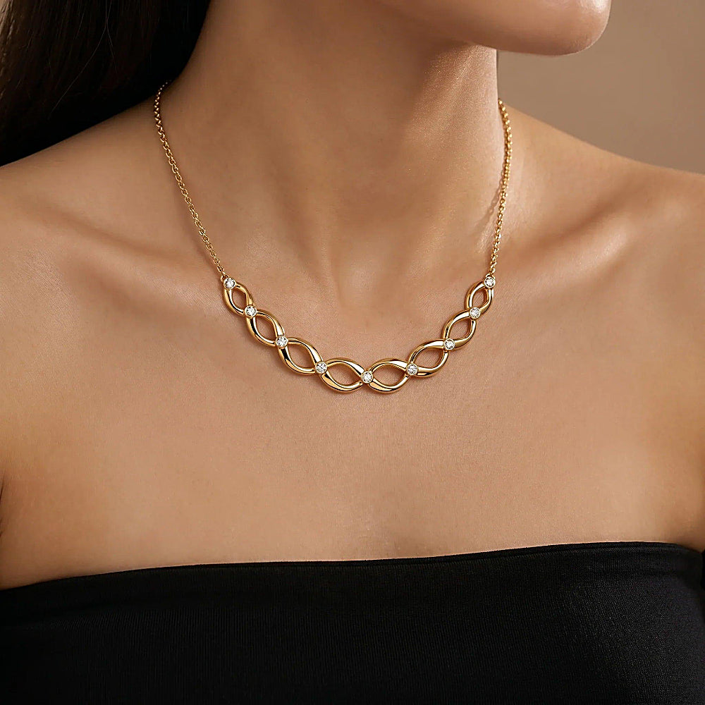 Discover the Ormiro DNA Necklace at The Luxe Maison, featuring a double-helix design with sparkling 5A cubic zirconia and 18K gold plating for a modern, elegant statement of individuality.