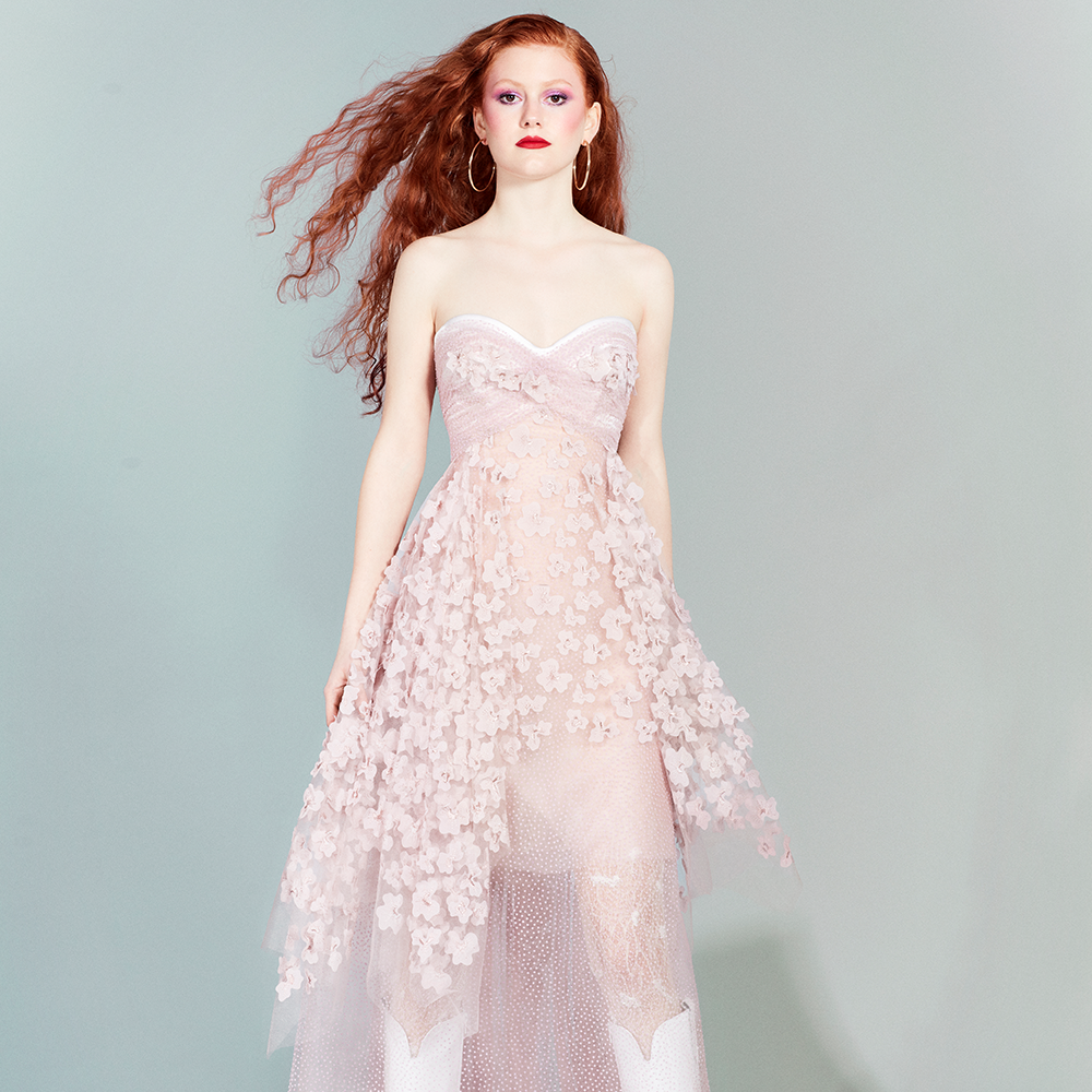 With a romantic style and a strapless sweetheart neckline, this dress made in pale pink tulle.