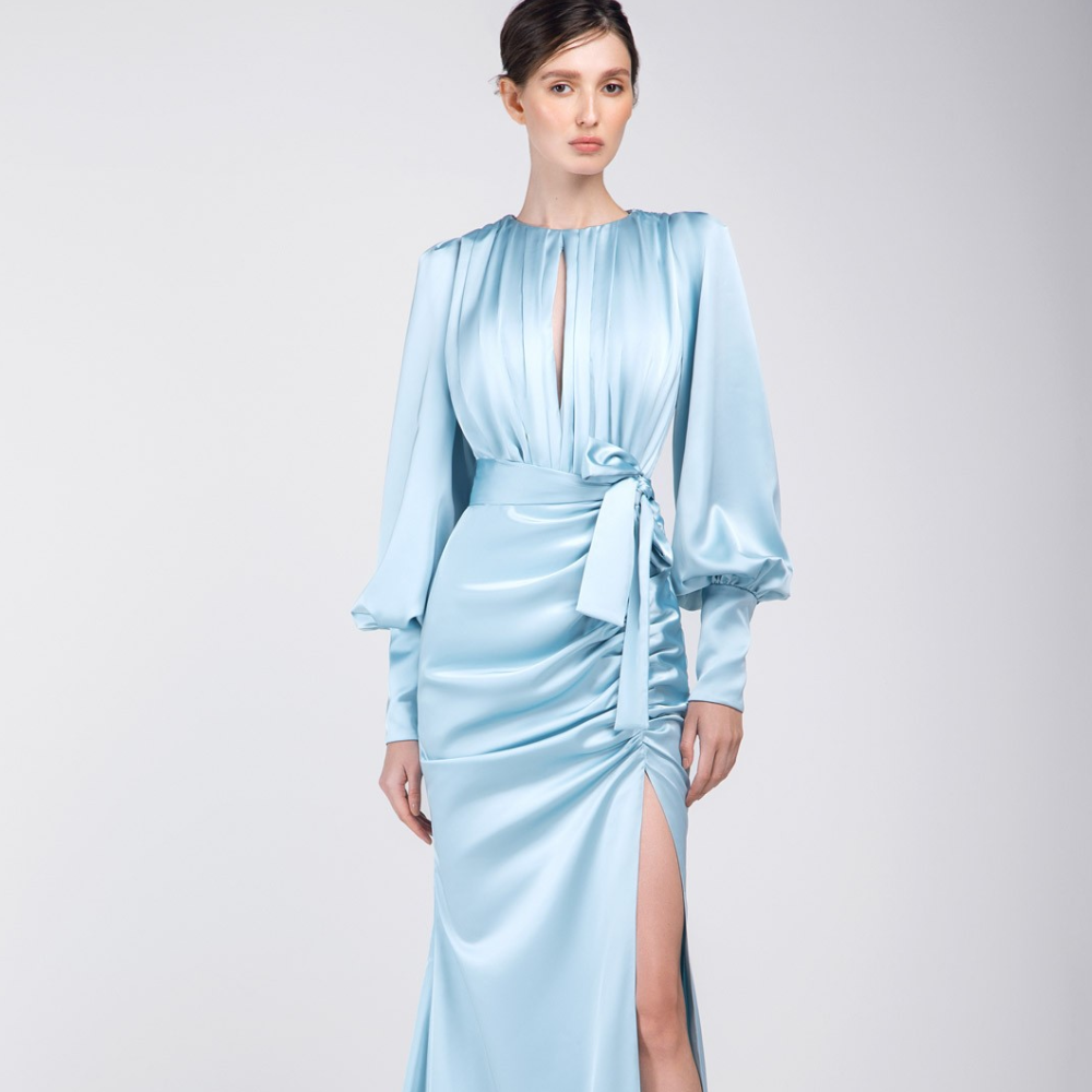 This long puff sleeves, floor length party dress is made for fashionista. It has front slit and waist belt too.