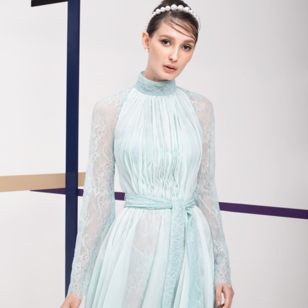 This dress is pastel green knee-length with high collar. Full sleeves and belt on waist.