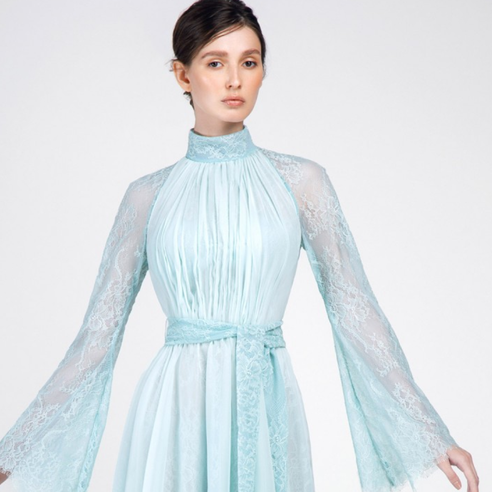 This dress is pastel green knee-length with high collar. Full sleeves and belt on waist.