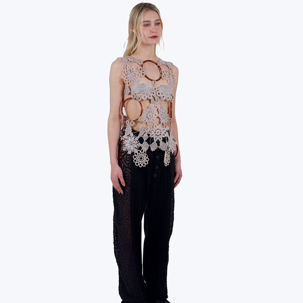 This is a one-of-a-kind top made from a patchwork of vintage crochet elements and plastic rings