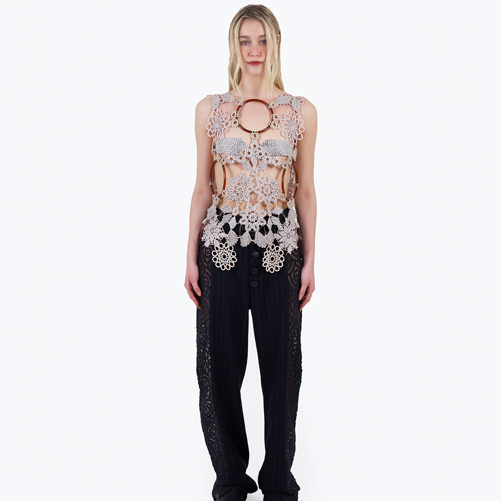 This is a one-of-a-kind top made from a patchwork of vintage crochet elements and plastic rings