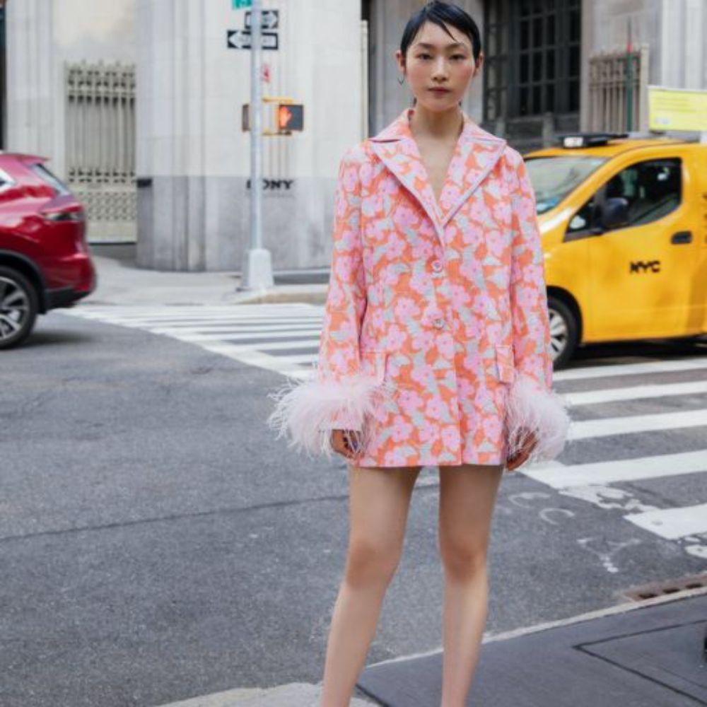 Jacquard pink jacket has belted waist, decorated with detachable feathers cuffs and an epaulet detail.