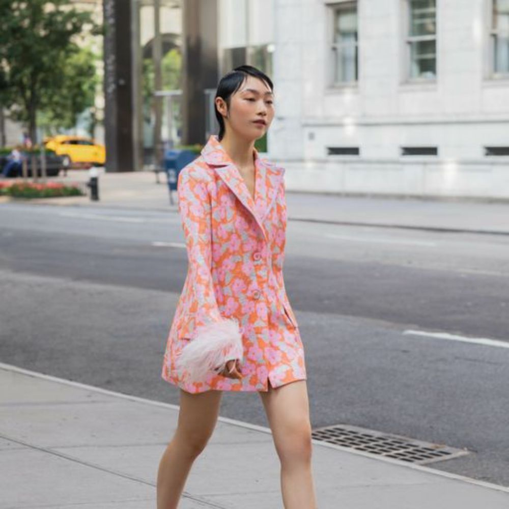 Jacquard pink jacket has belted waist, decorated with detachable feathers cuffs and an epaulet detail.