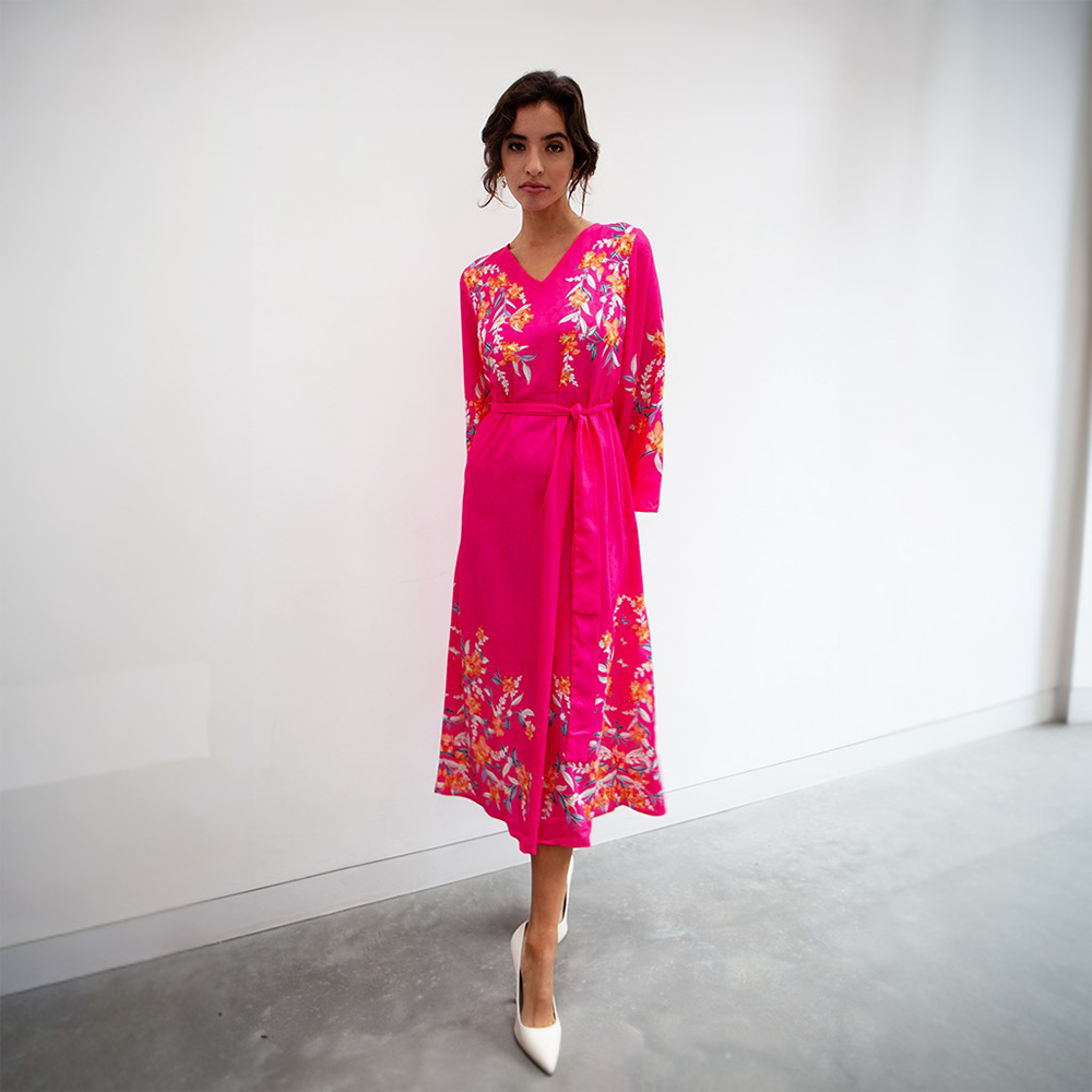 This bright hot pink midi dress features a V neckline, tie-up belt and full length sleeves.