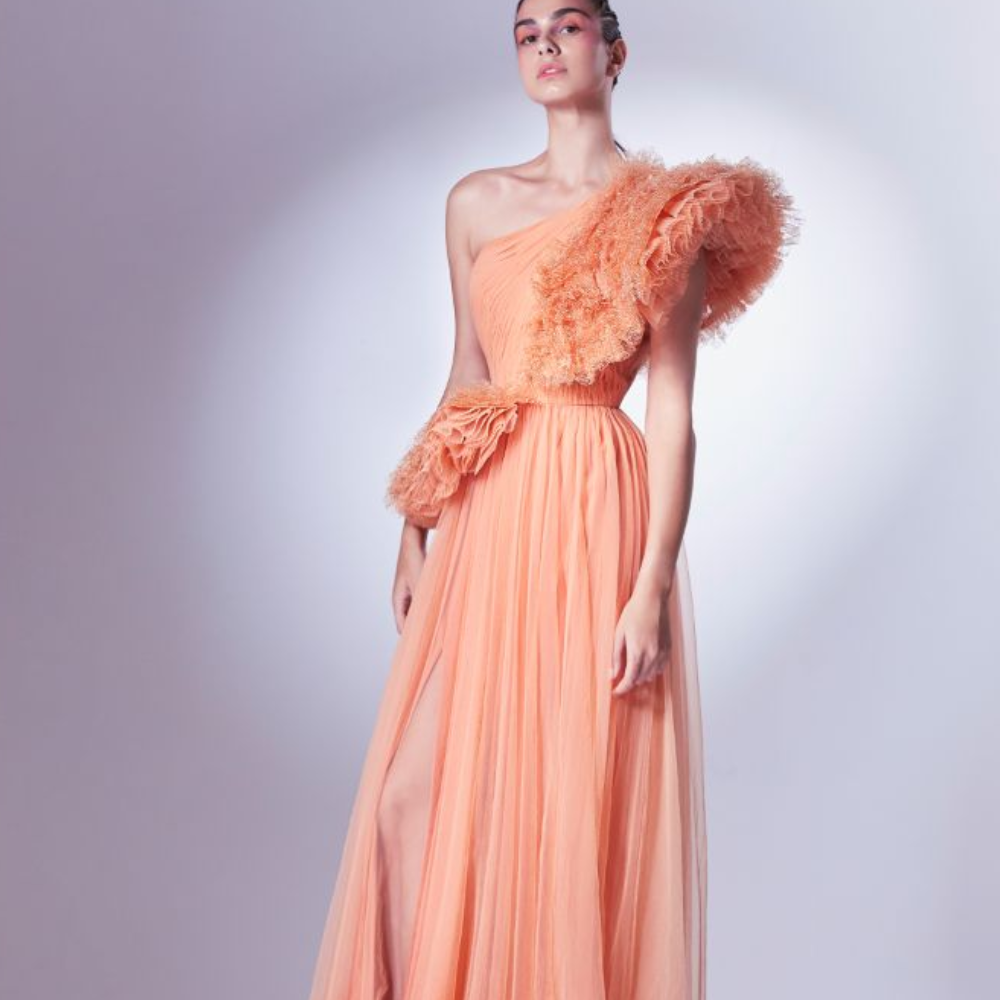 Rendered in a vibrant orange, this one shoulder dress is constructed with intrinsic draping on the bust.