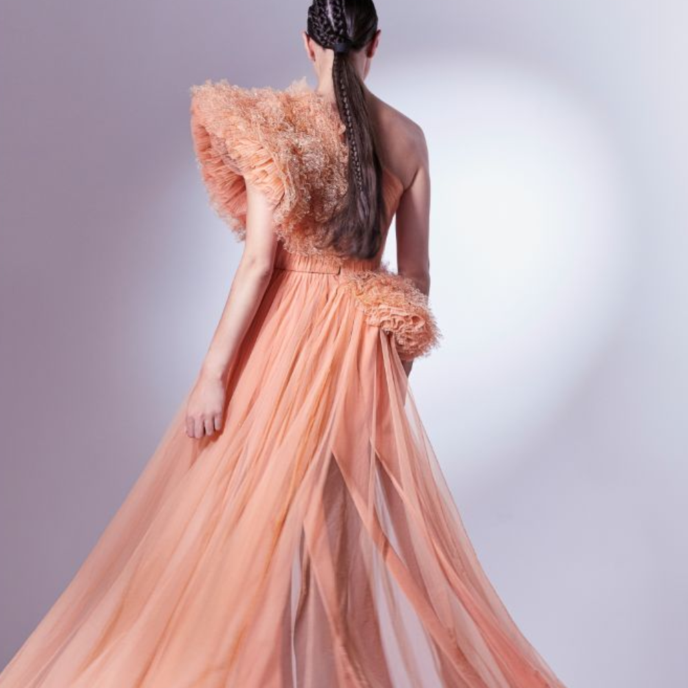 Rendered in a vibrant orange, this one shoulder dress is constructed with intrinsic draping on the bust.