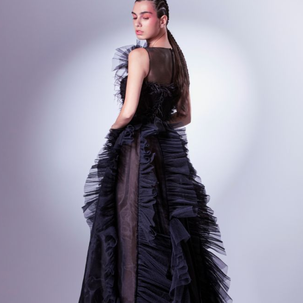 A mix of boldness and sensuality, this daring dress boasts a draped tulle and ostrich feathers corset. 