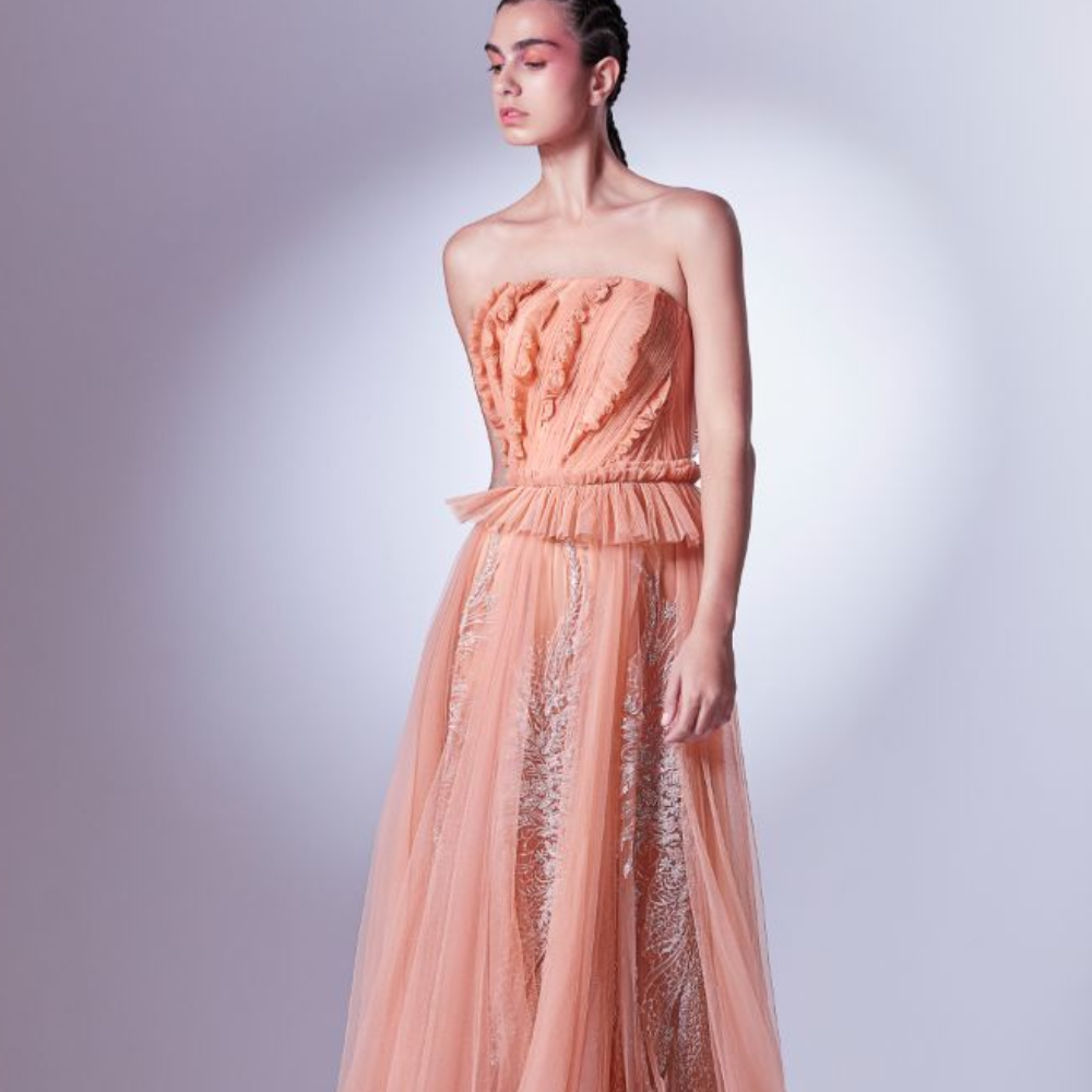 Designed in a daring coral color, this dress is carefully draped and pleated at the bodice, accentuating the waistline.