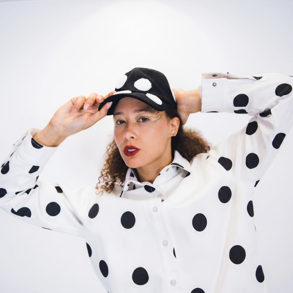 Black structured cap with bold 3D polka dots. Shop premium designer styles online.