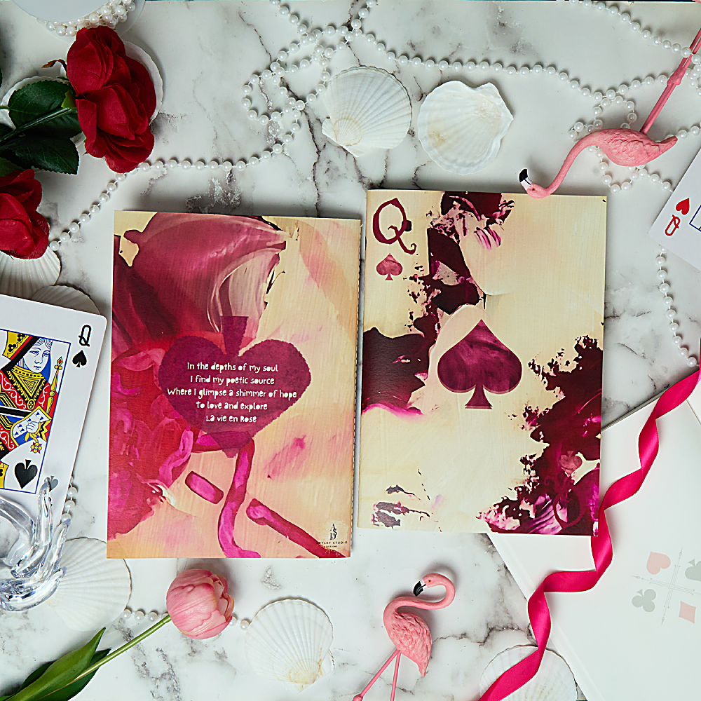 Discover the Queen of Spades Notebook at The Luxe Maison, featuring pink and ivory folds, a translucent vellum cover, and personalized rhyme options. Made in Dubai.