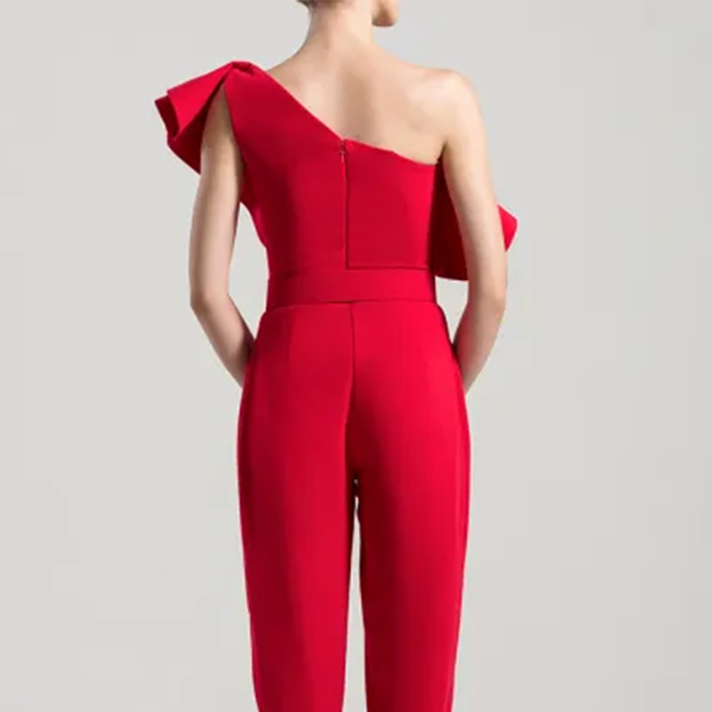 One shoulder crepe jumpsuit with an elaborated multi-layered peplum. 