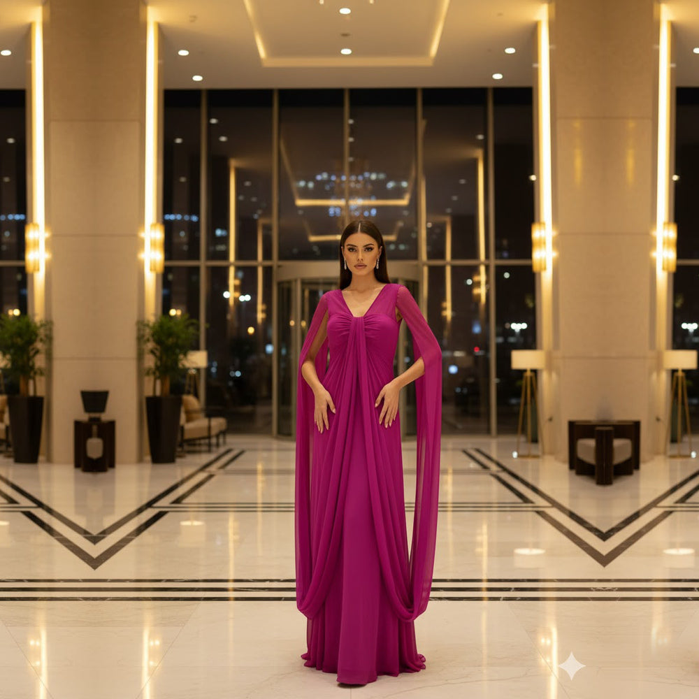 Shop online from our exclusive website. Discover the Rhea fuchsia maxi gown featuring a flowing silhouette, graceful drape, and timeless elegance for weddings, galas, and special occasions.
