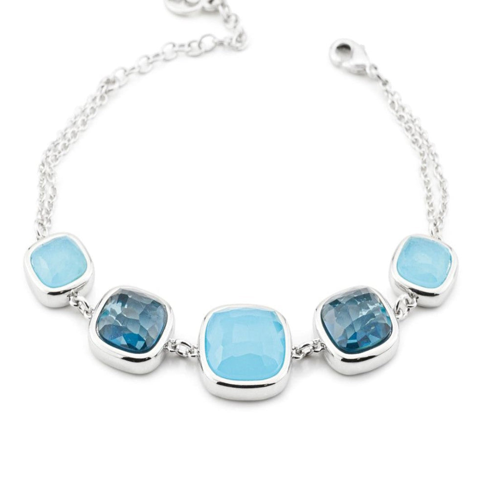 Rhodium-plated bronze bracelet with milky blue and aquamarine crystal accents in varied sizes for a fresh contemporary finish. Shop premium jewelry online.