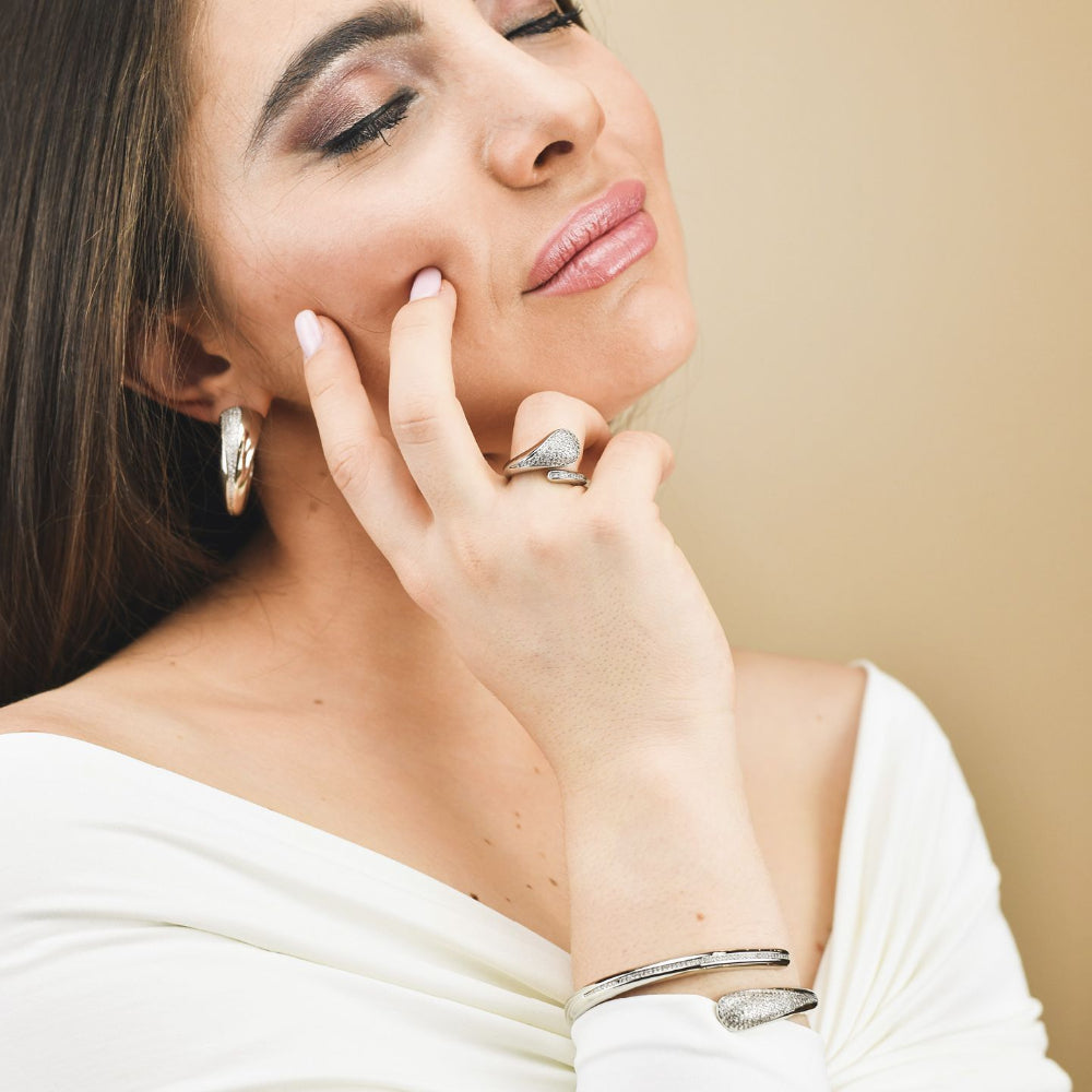 Shop online premium rhodium plated oval hoop earrings with sparkling pavé cubic zirconia detailing for elegant modern styling.