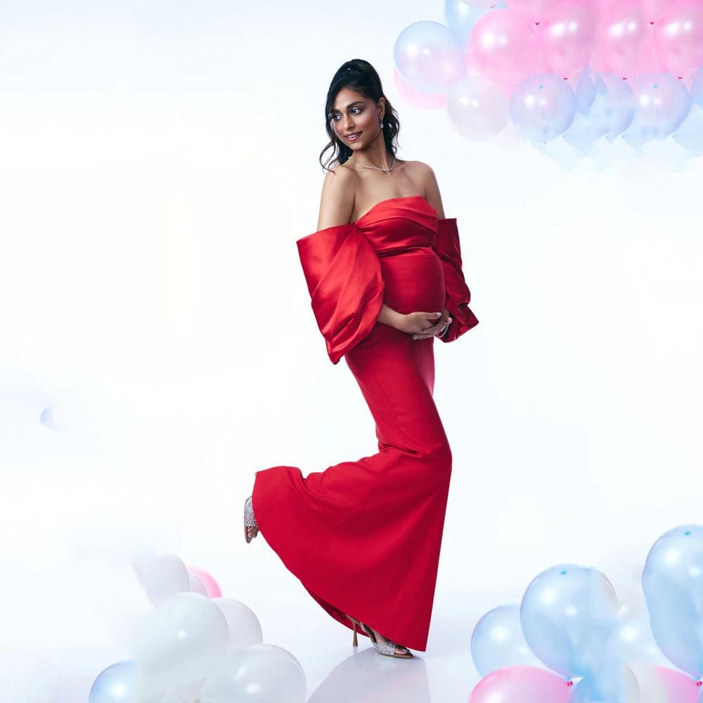 Red maternity dress with satin pleats and off shoulder sleeves, perfect for events. Shop online from our curated edit of premium fashion.