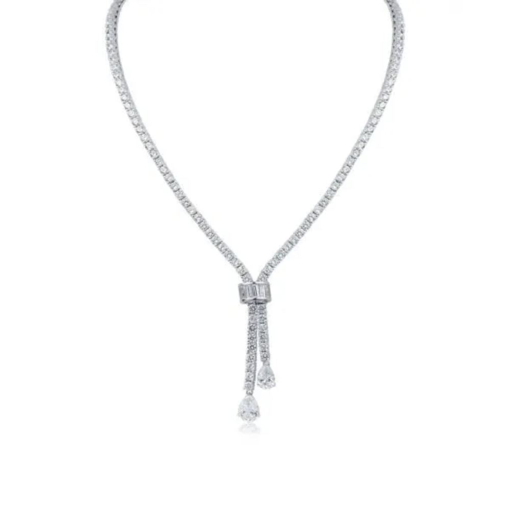 30CTTW Round Cubic Zirconia necklace with baguette and pear CZ double drop. Box clasp closure. Set in rhodium plated brass.