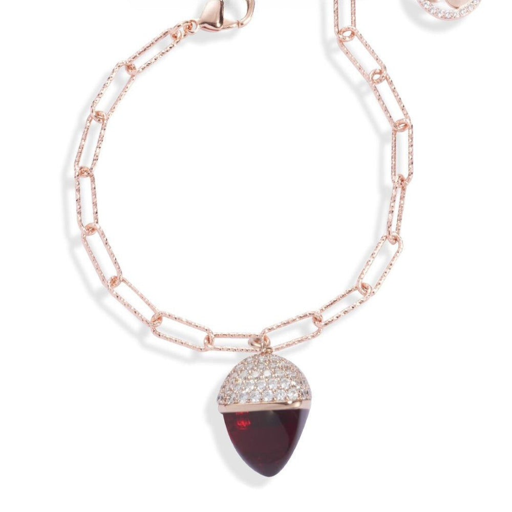 Elegant rose gold plated bracelet with a ruby-colored pyramid crystal pendant and sparkling cubic zirconia diamond-cut links. Perfect for luxe styling. Shop premium jewelry online.