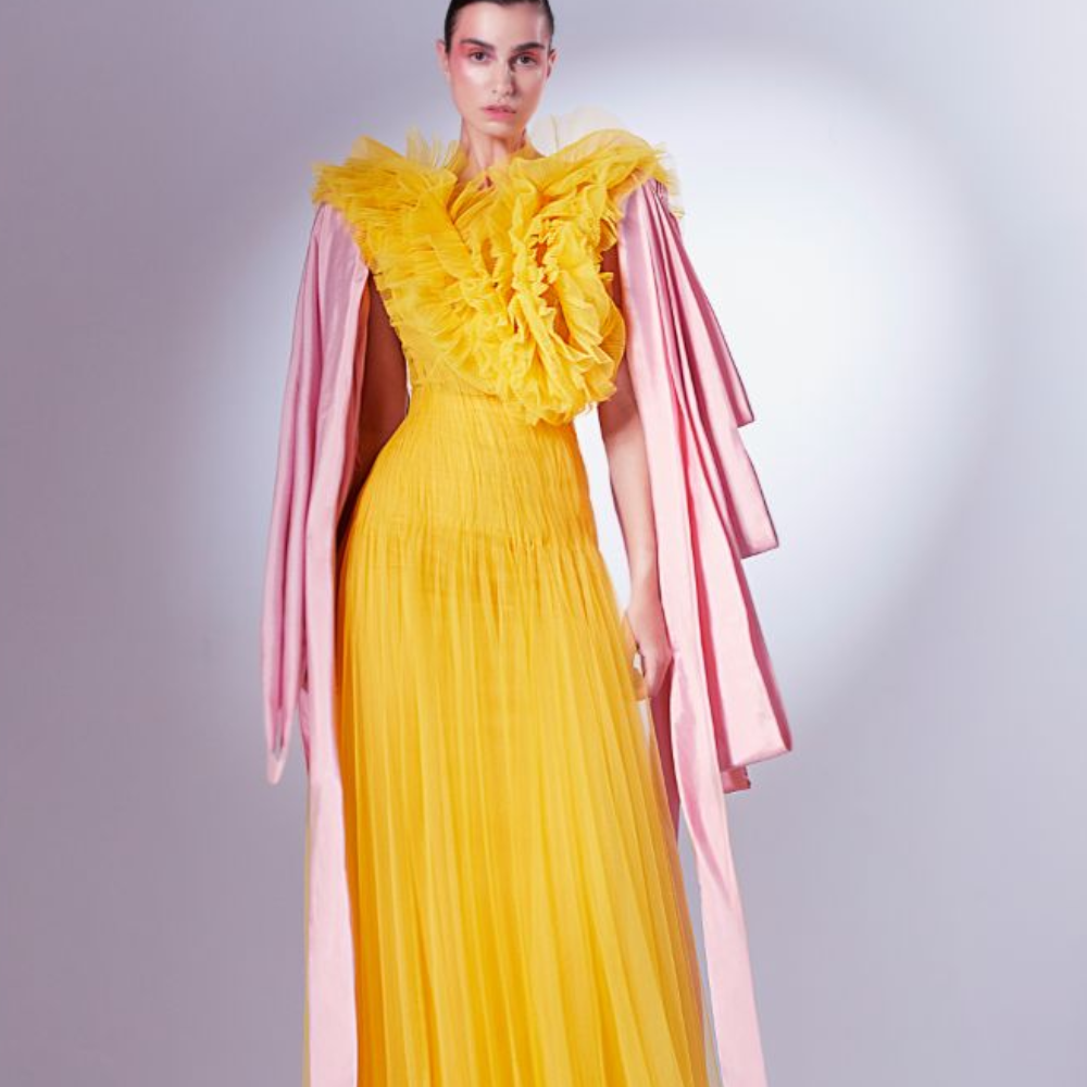 Rendered in a vibrant Mango yellow, it starts off with random chaotic frills of normal and pleated tulle at the bodice.