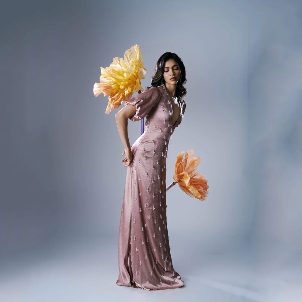 Peach satin maxi dress with V-neck, puff sleeves and crystal tassels, perfect for events. Shop online from our exclusive collection of premium styles.