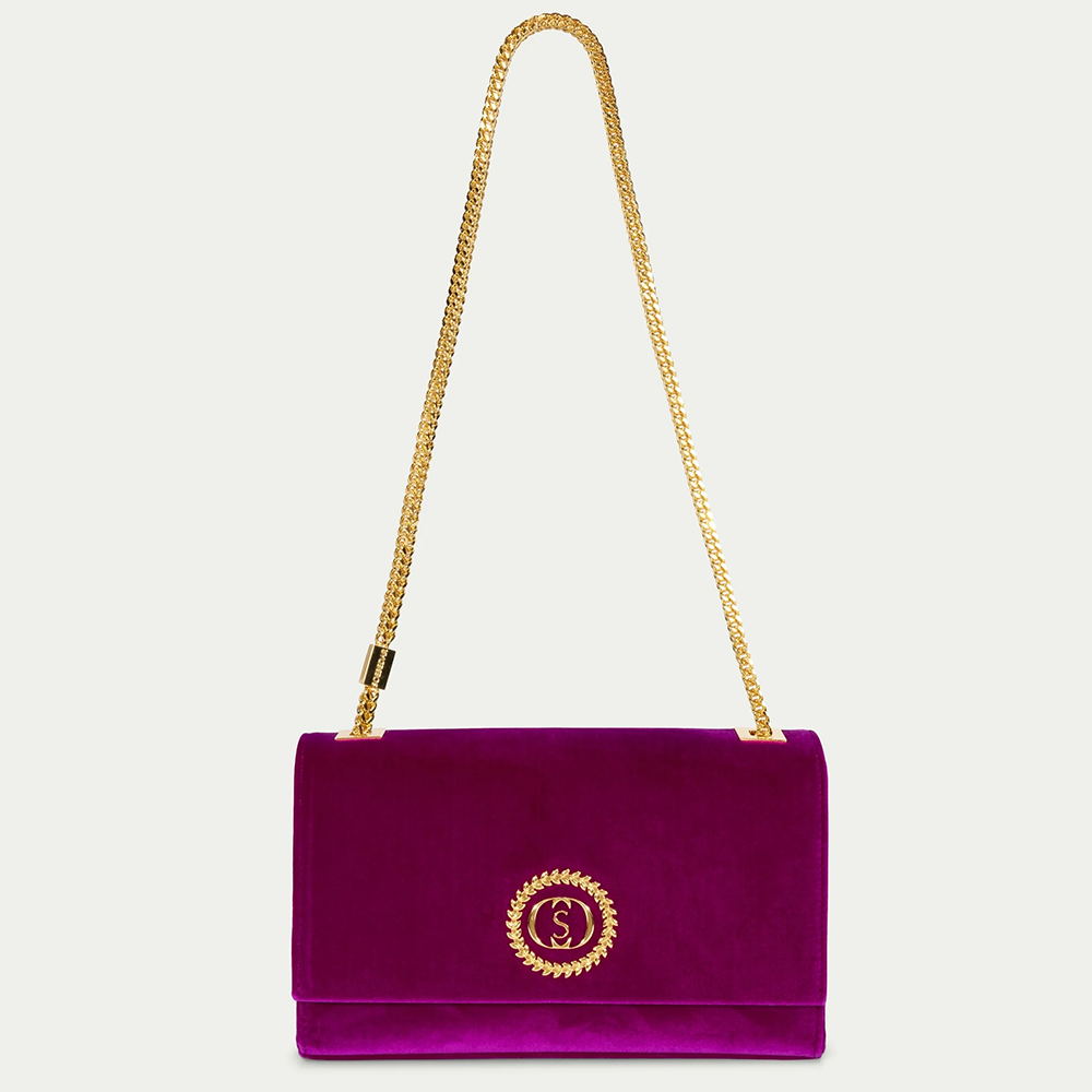 This velvet bag is hand-finished in Italy with gold plated hardware.